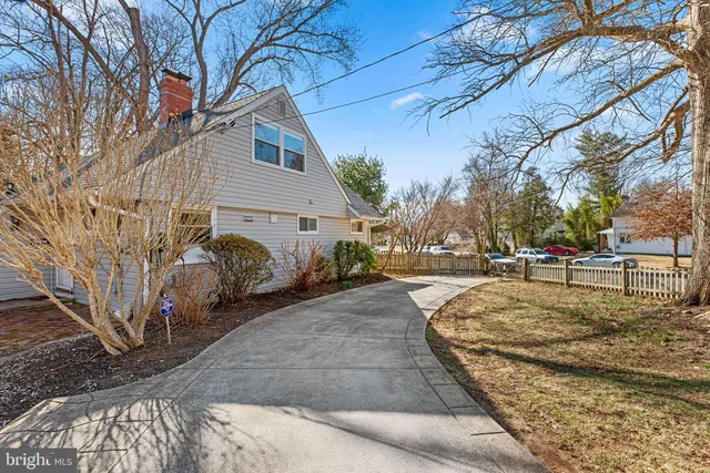 a view of a white house with a yard covered in snow