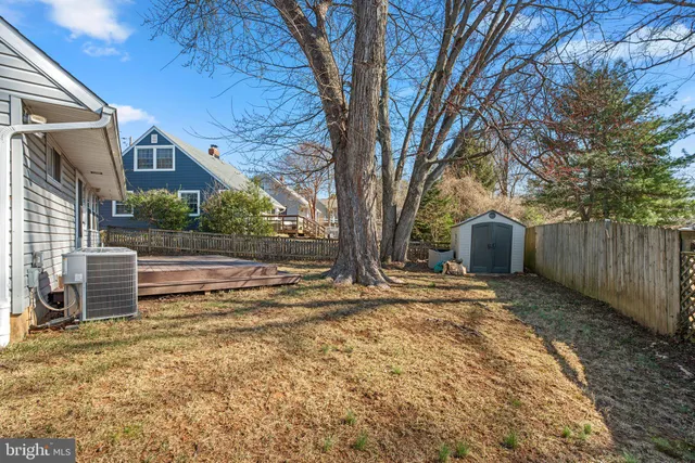 a view of a yard with wooden fence