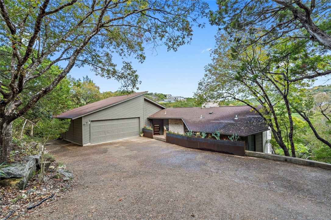 304 Yaupon Valley Road West Lake Hills, TX 78746 - Photo 1 of 1 a view of a house with a large tree and a big yard