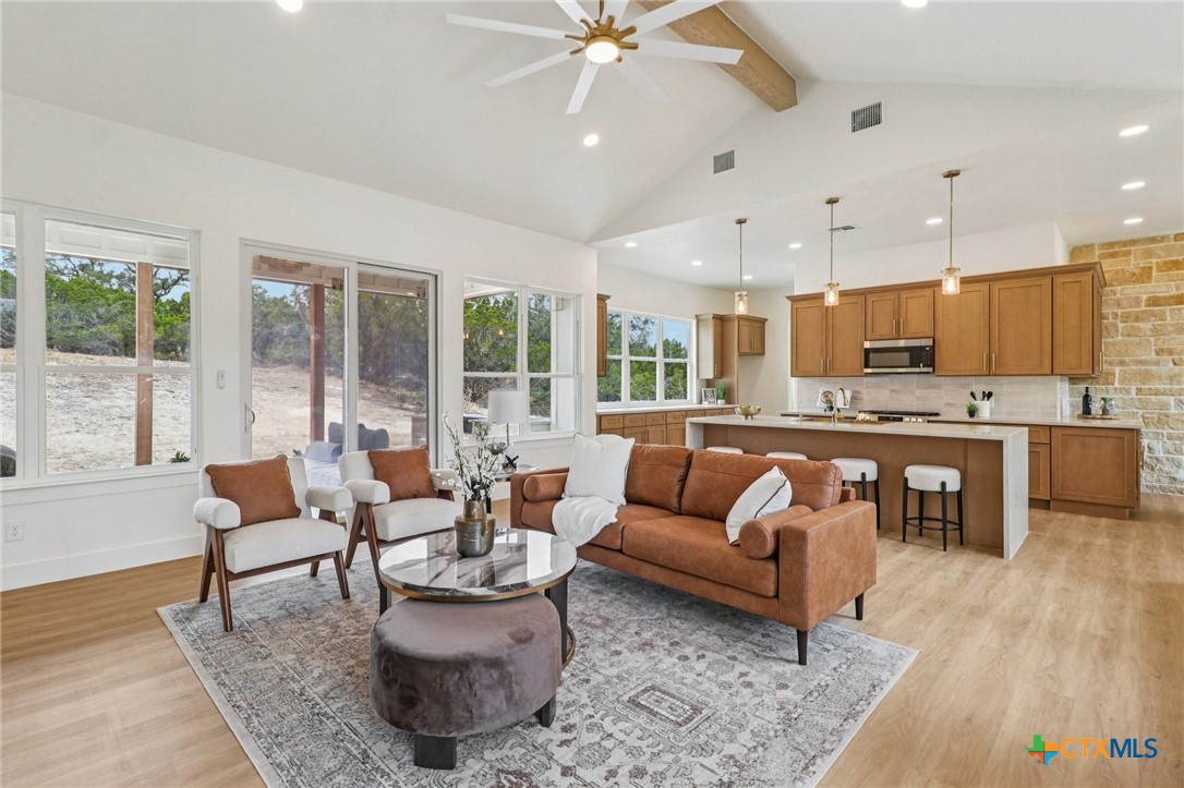 858 Rutherford Fischer, TX 78623 - Photo 12 of 37 a living room with furniture and kitchen view