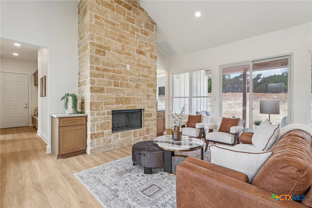 858 Rutherford Fischer, TX 78623 - Photo 14 of 37 a living room with furniture and a fireplace