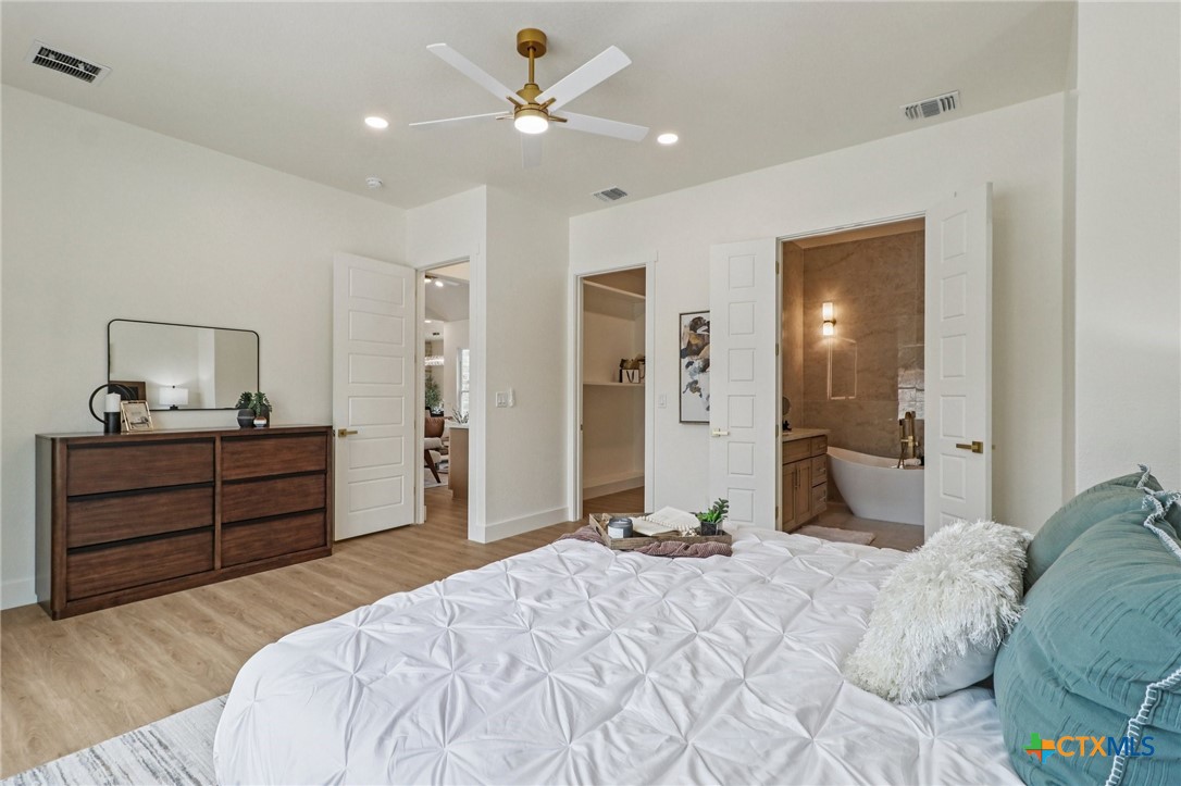 858 Rutherford Fischer, TX 78623 - Photo 17 of 37 a bedroom with a bed and a chandelier