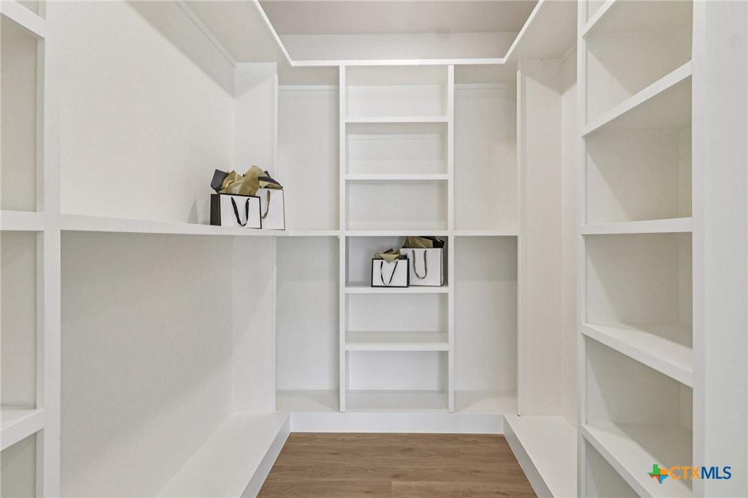 858 Rutherford Fischer, TX 78623 - Photo 20 of 37 a view of walk in closet with empty racks