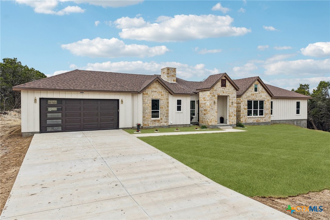 858 Rutherford Fischer, TX 78623 - Photo 2 of 37 a front view of a house with a garden and yard