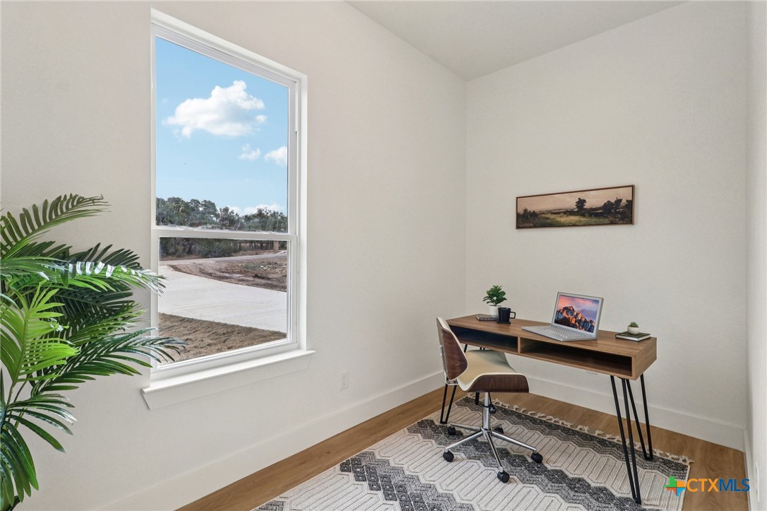 858 Rutherford Fischer, TX 78623 - Photo 22 of 37 a workspace with furniture and a potted plant
