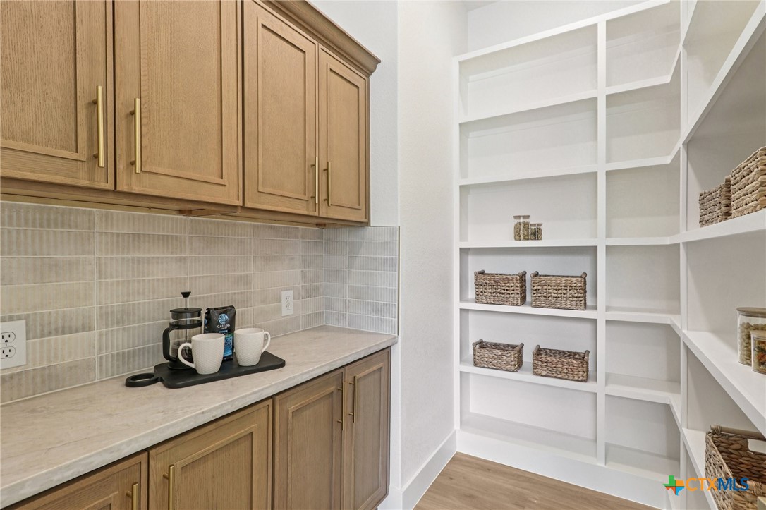 858 Rutherford Fischer, TX 78623 - Photo 10 of 37 a kitchen with white cabinets and a sink