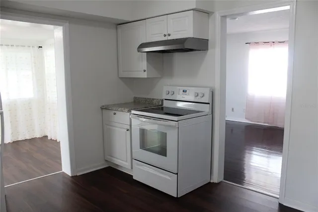 a stove top oven sitting inside of a kitchen