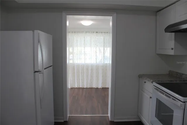 a kitchen with a refrigerator and window