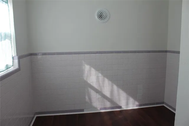 a view of empty room with hardwood floor