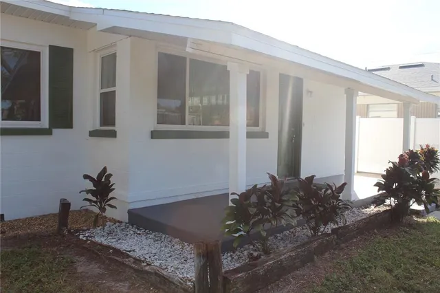 a potted plant sitting in front of a house