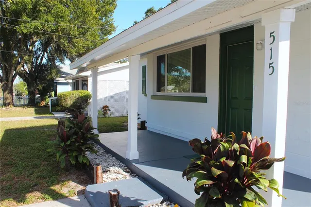 a vase of flowers sitting on a table in front of a house