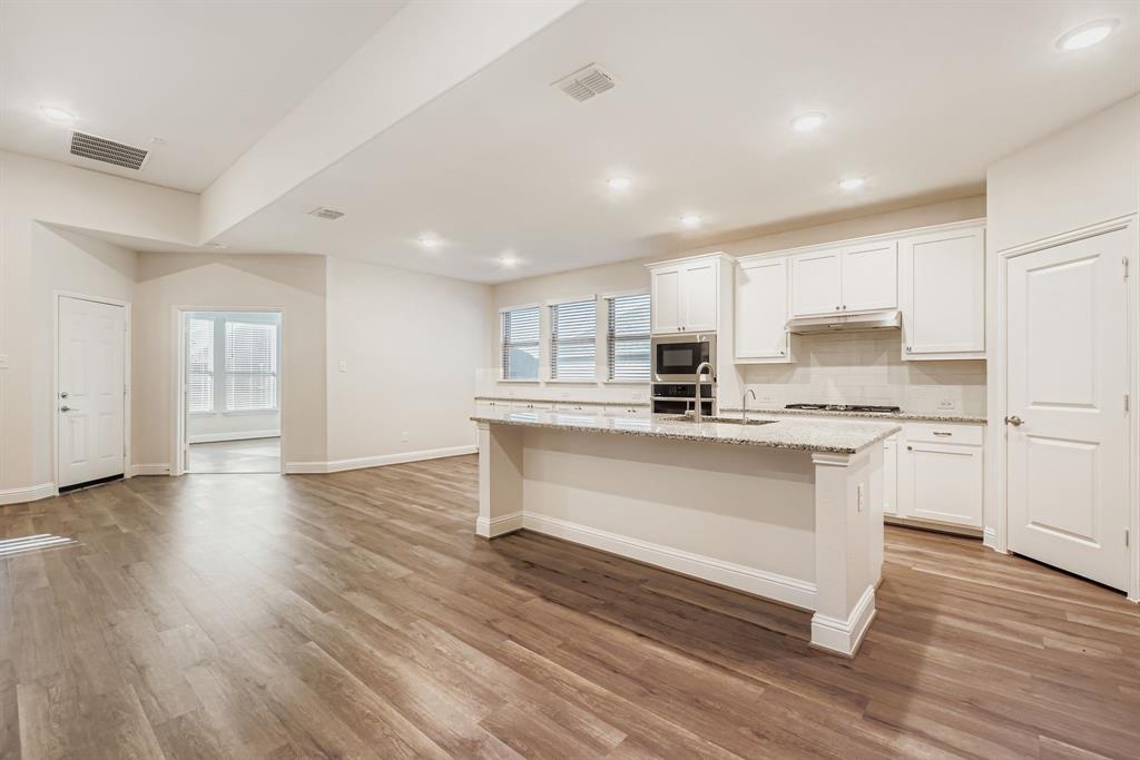 312 Magnolia Drive Oak Point, TX 75068 - Photo 10 of 28 Kitchen with tasteful backsplash, healthy amount of natural light, white cabinetry, and recessed lighting