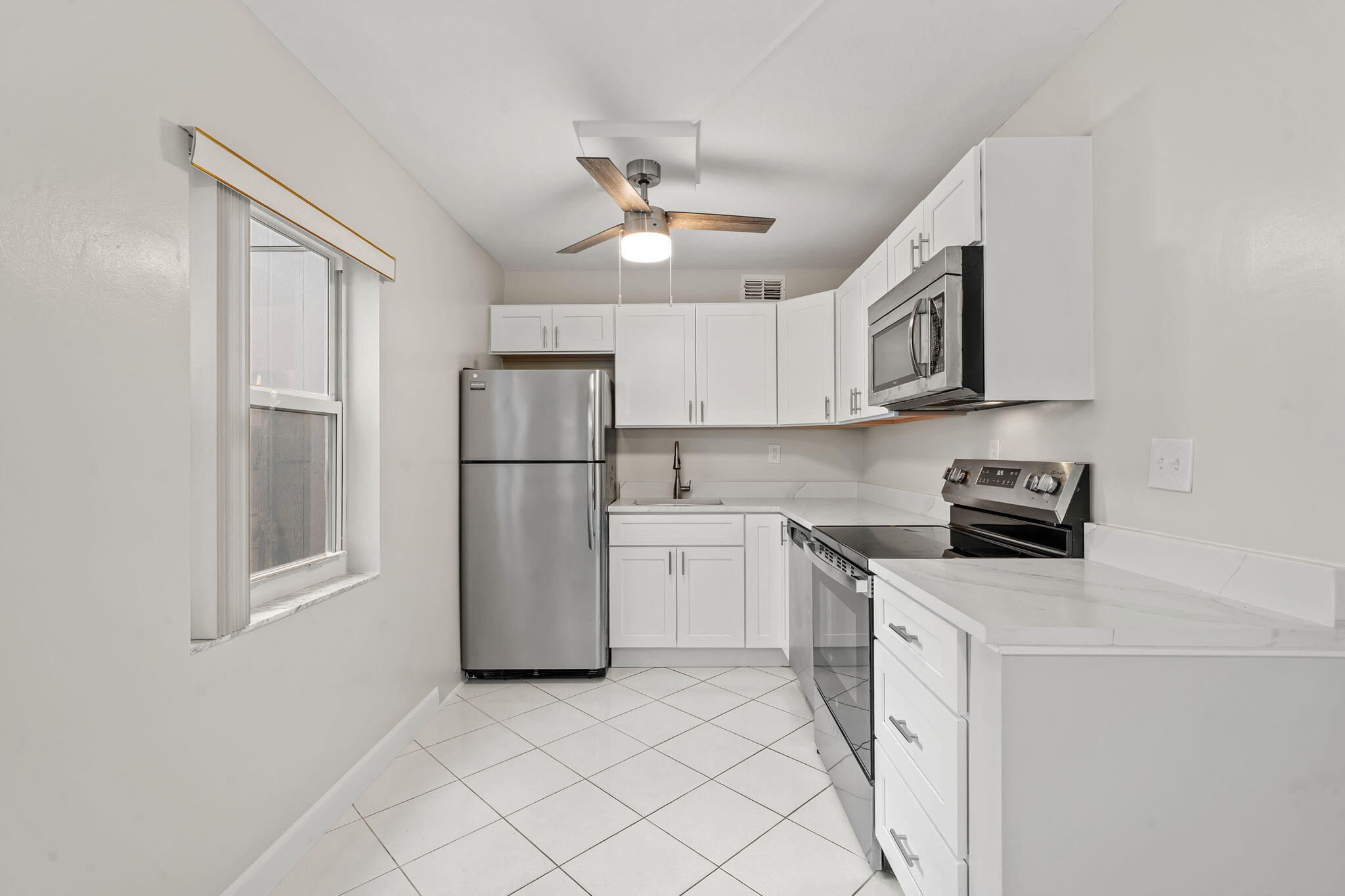 932 Flanders T Delray Beach, FL 33484 - Photo 1 of 28 a kitchen with stainless steel appliances a refrigerator sink and cabinets