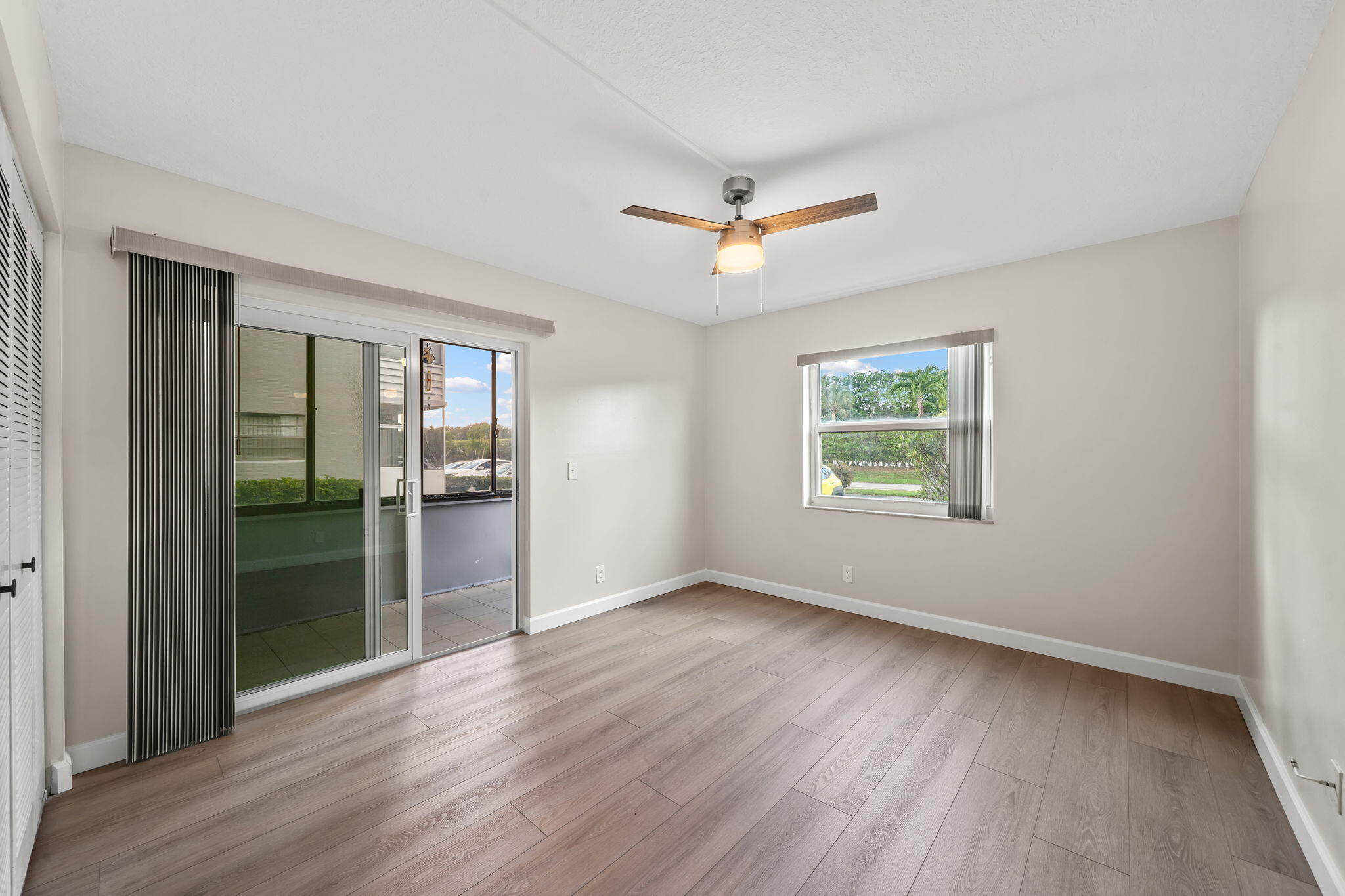 932 Flanders T Delray Beach, FL 33484 - Photo 12 of 28 wooden floor in an empty room with a window