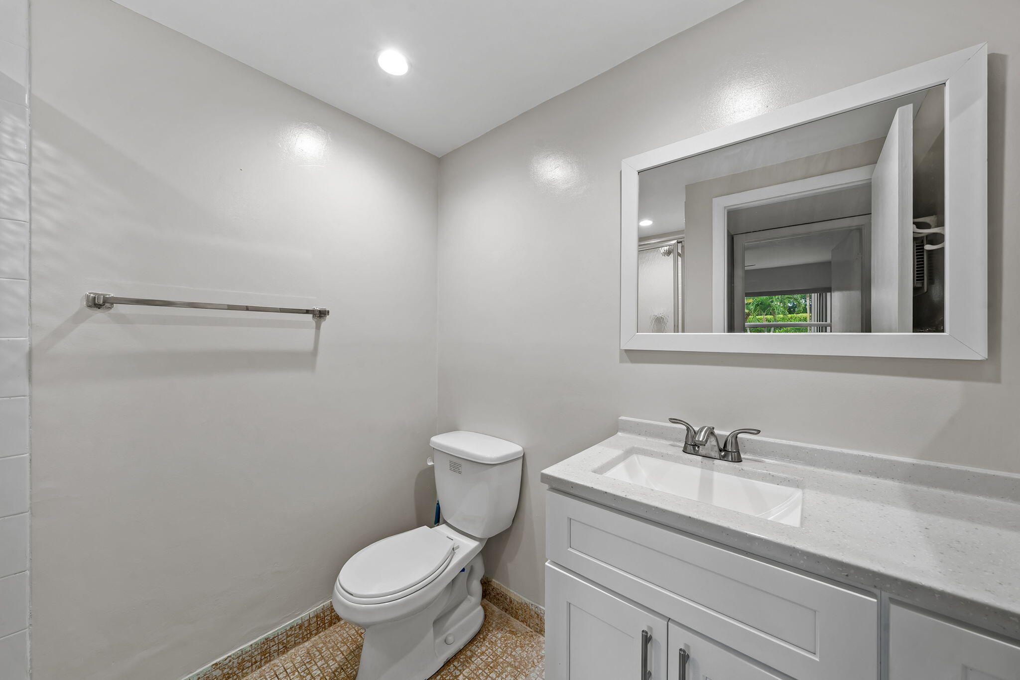932 Flanders T Delray Beach, FL 33484 - Photo 13 of 28 a bathroom with a sink toilet and vanity