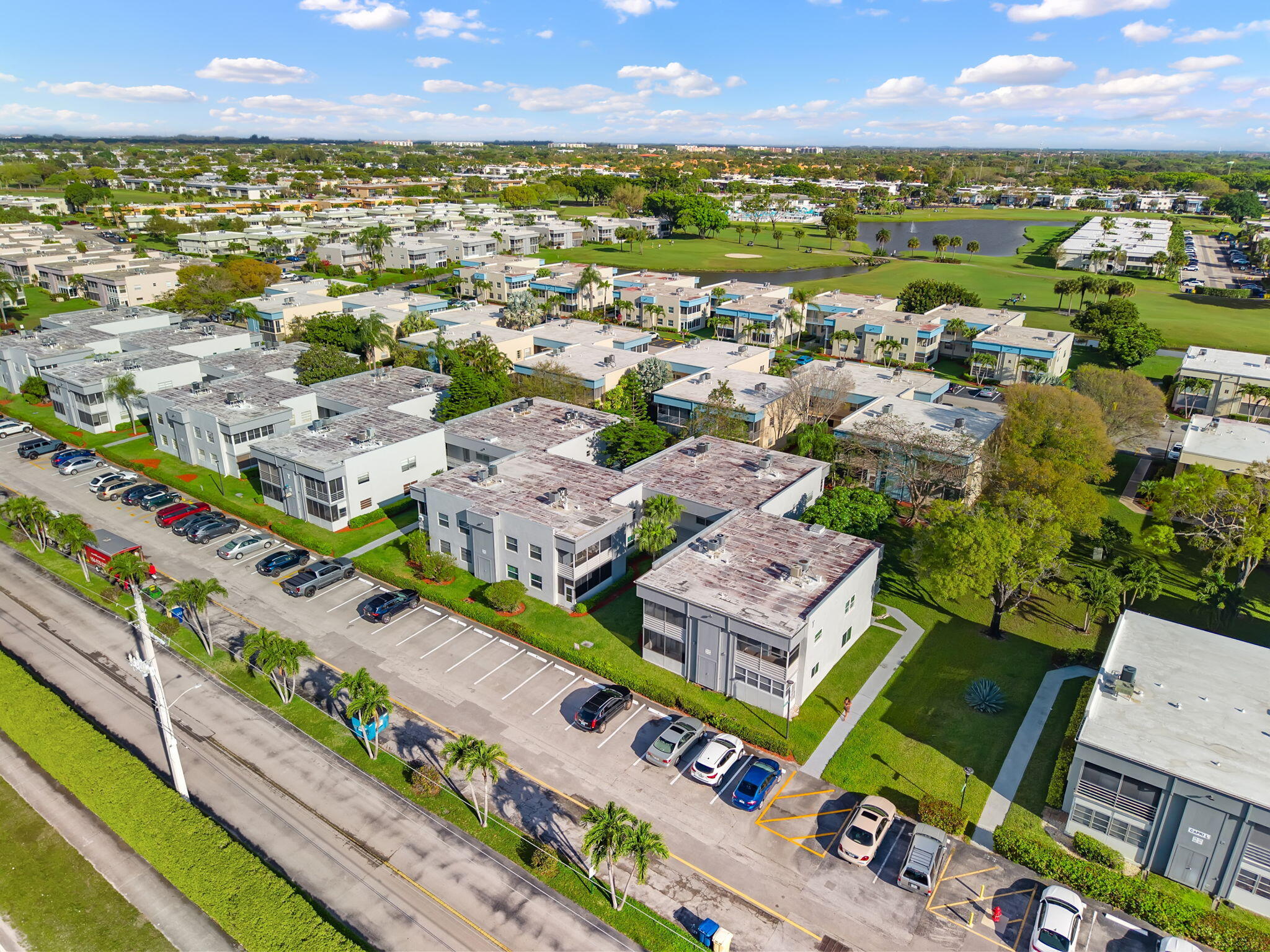 932 Flanders T Delray Beach, FL 33484 - Photo 22 of 28 an aerial view of a city with lots of residential buildings and mountain view in back