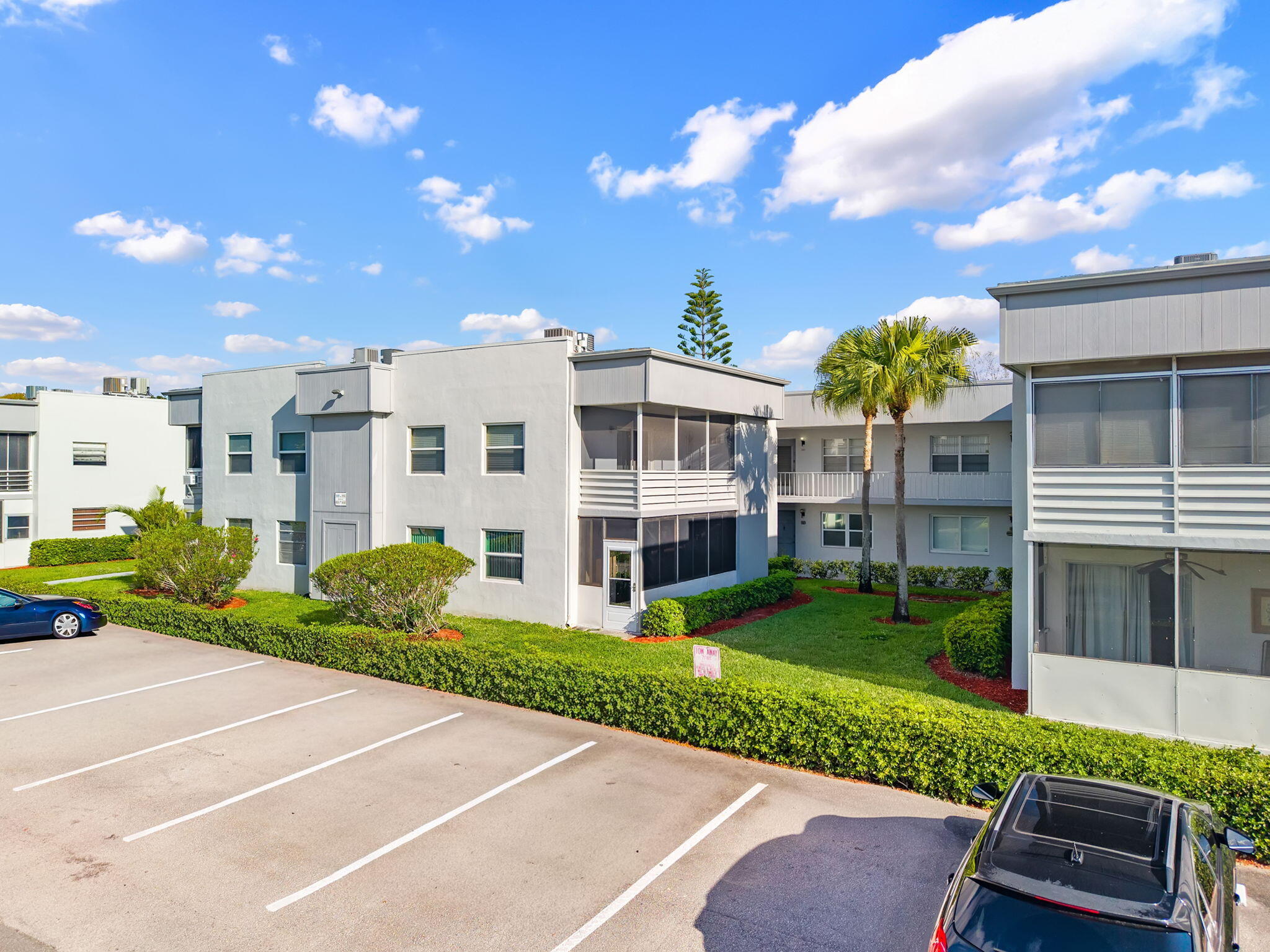 932 Flanders T Delray Beach, FL 33484 - Photo 3 of 28 a view of a big yard and front view of a building