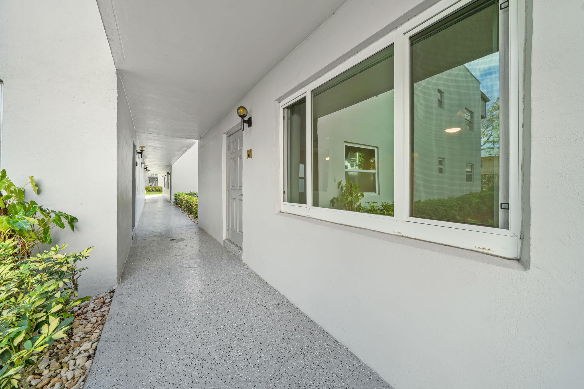 932 Flanders T Delray Beach, FL 33484 - Photo 4 of 28 a view of a hallway with windows