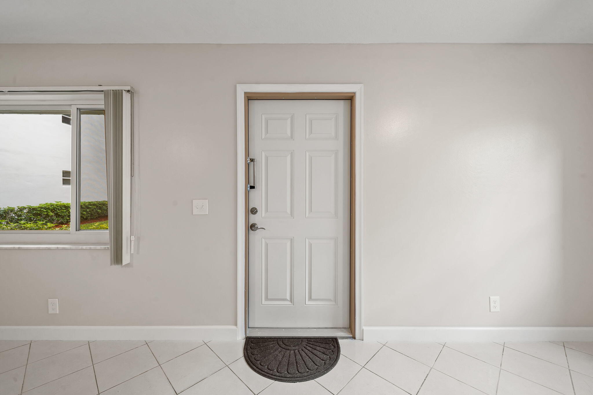 932 Flanders T Delray Beach, FL 33484 - Photo 6 of 28 a view of an entryway with wooden floor and a carpet