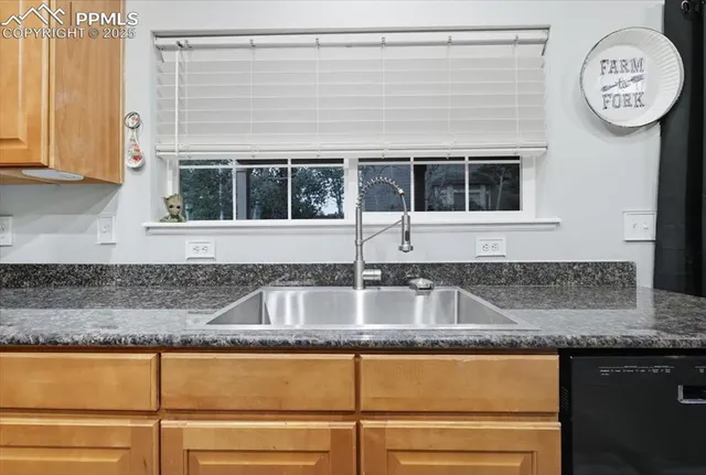 a kitchen with granite countertop a sink and cabinets