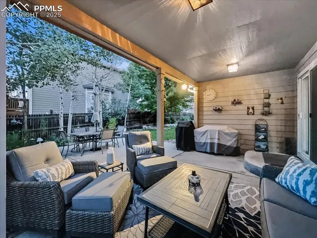 a living room with furniture fireplace and a large window