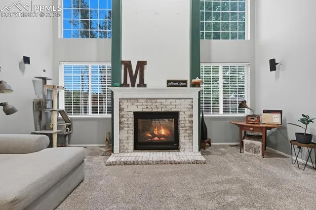 a living room with furniture a fireplace and a window