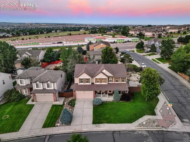an aerial view of residential houses with outdoor space and street view
