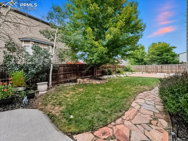a front view of a house with a garden and yard