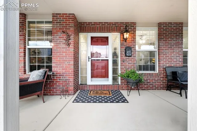 a view of a patio with a table and chairs