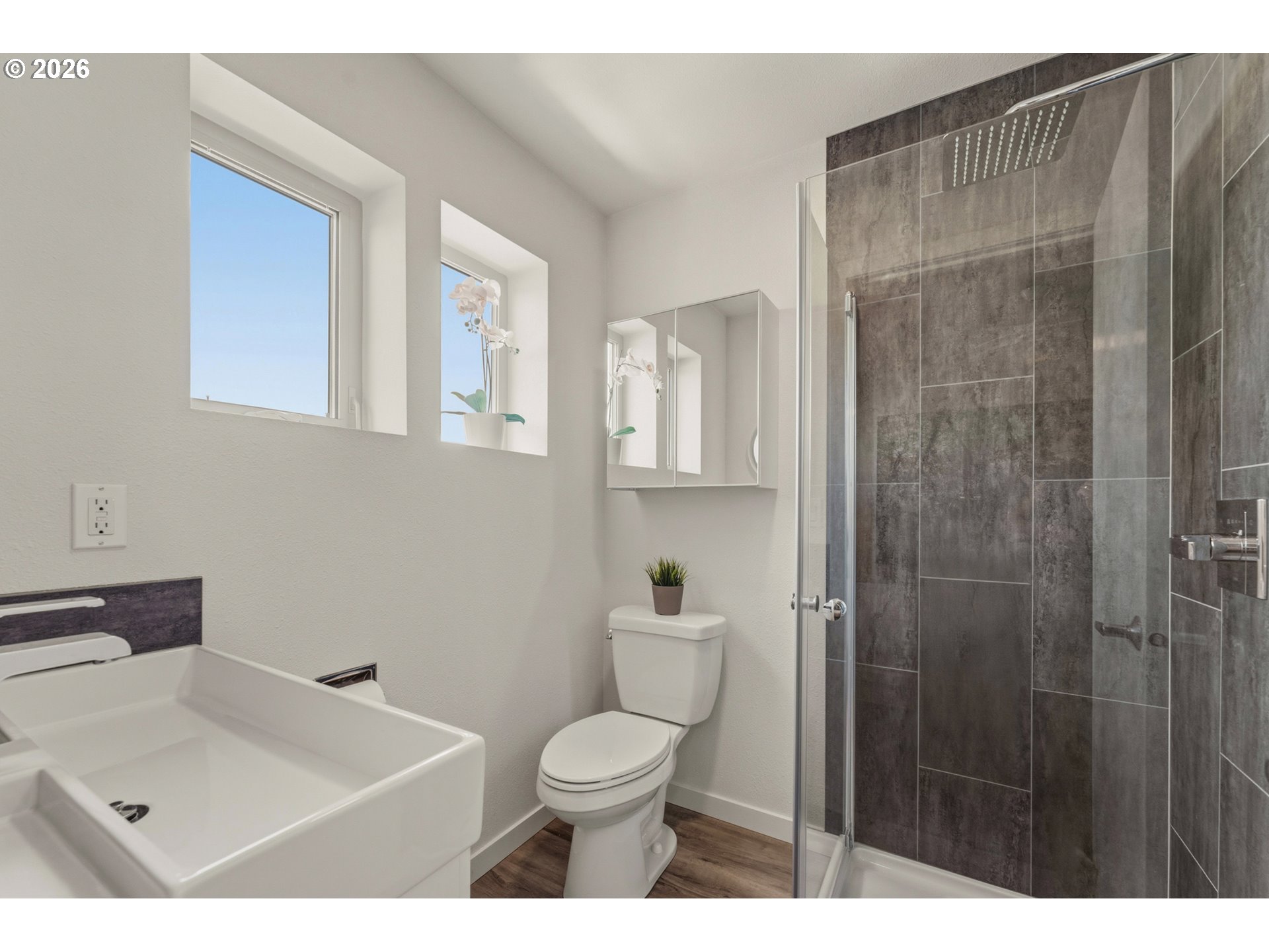 14794 Southwest Watershed Lane Beaverton, OR 97007 - Photo 25 of 46 a bathroom with a toilet sink vanity and shower