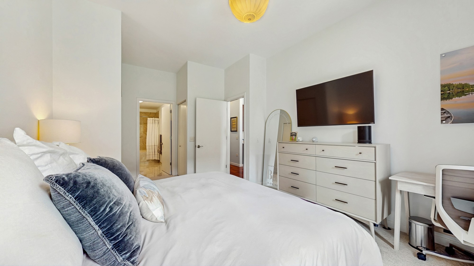 3920 North Sheridan Road, Unit 411 Chicago, IL 60613 - Photo 18 of 28 a bedroom with a bed and a flat screen tv