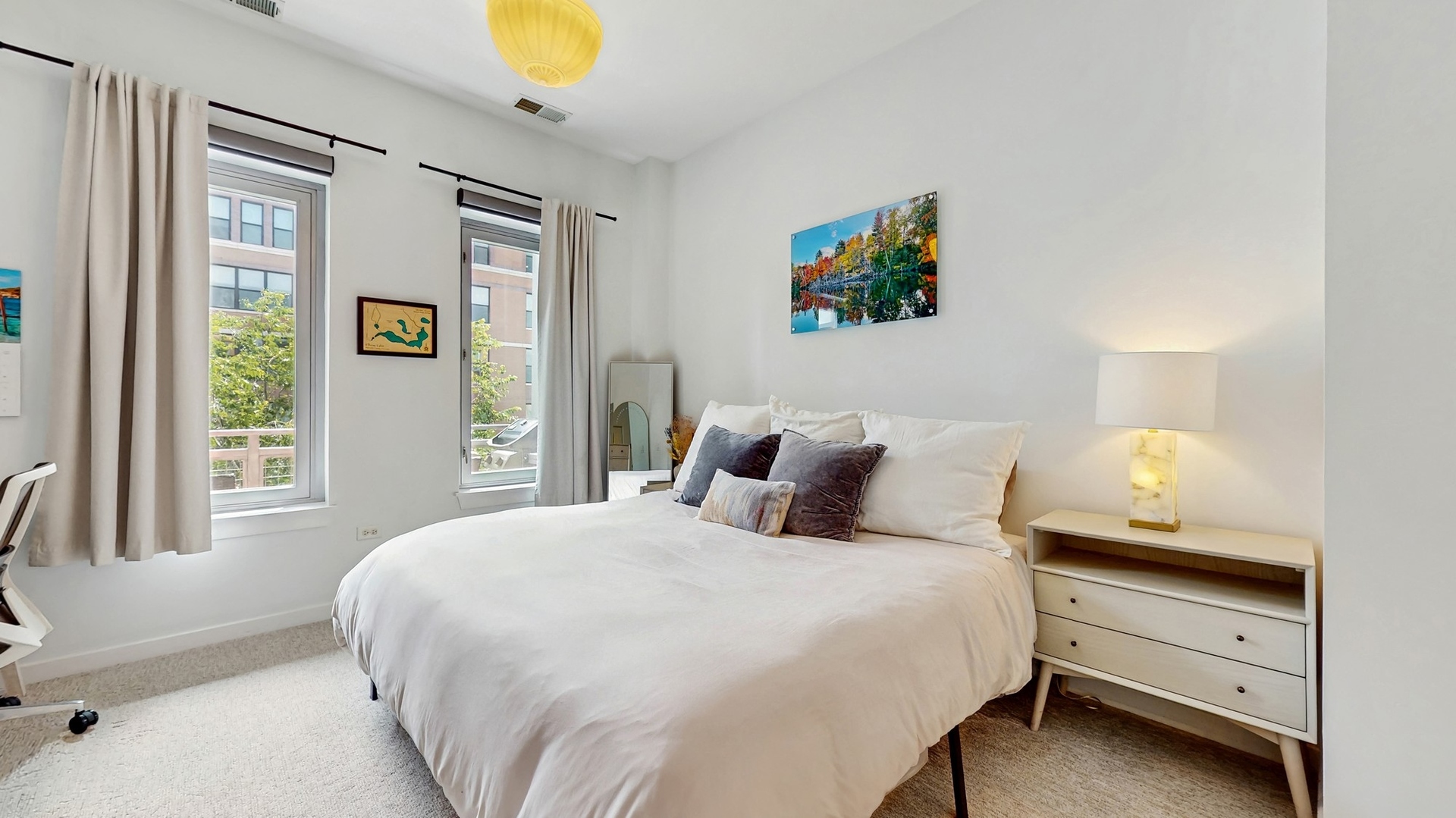 3920 North Sheridan Road, Unit 411 Chicago, IL 60613 - Photo 5 of 28 a bedroom with a bed and a painting on the wall