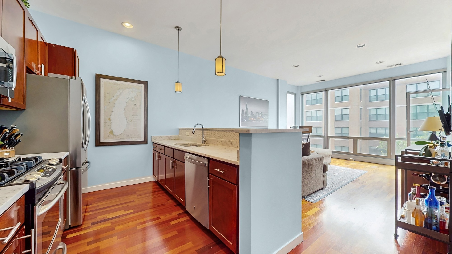 3920 North Sheridan Road, Unit 411 Chicago, IL 60613 - Photo 9 of 28 a kitchen with stainless steel appliances granite countertop a sink stove and refrigerator