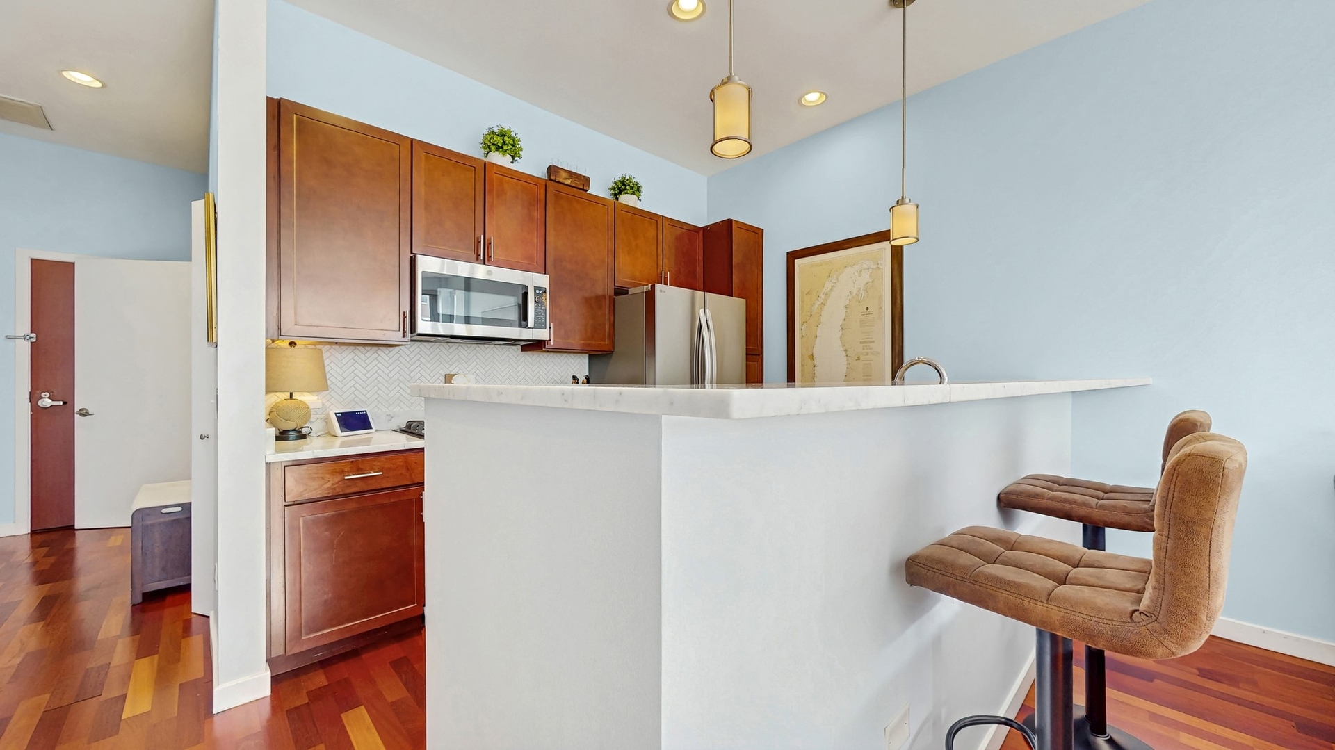 3920 North Sheridan Road, Unit 411 Chicago, IL 60613 - Photo 10 of 28 a kitchen with stainless steel appliances granite countertop a refrigerator and a stove top oven