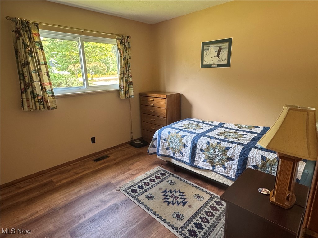 8810 Auburn Road Chardon, OH 44024 - Photo 14 of 22 Bedroom featuring wood finished floors and baseboards