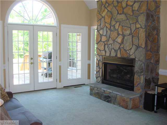 6365 Robinhood Road Pfafftown, NC 27040 - Photo 3 of 16 Living Room. Vaulted ceilings, beautiful windows, and a stone fireplace surround you and your family in the heart of your home.