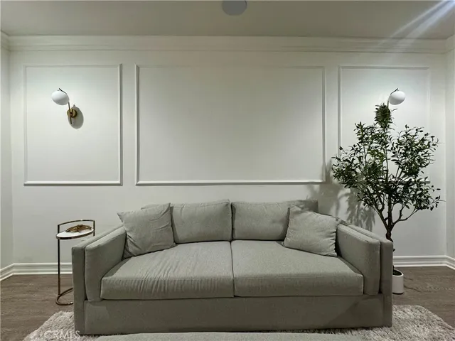 a living room with furniture and a potted plant