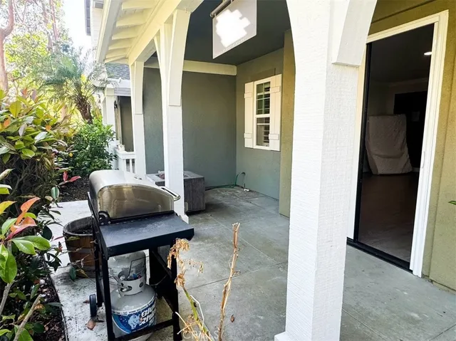 a backyard of a house with table and chairs