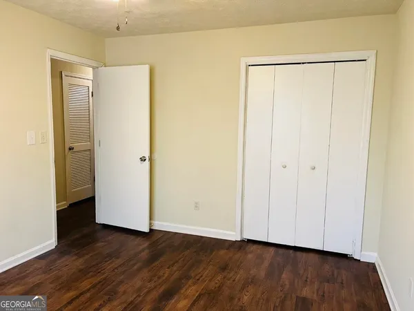 a view of an empty room with wooden floor