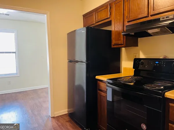 a kitchen with a refrigerator and a stove