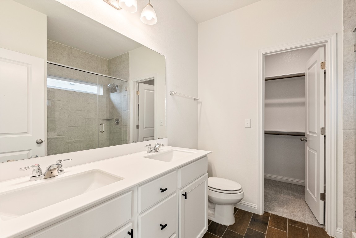 10708 Blacket Drive Austin, TX 78747 - Photo 16 of 20 a bathroom with a sink a toilet and shower