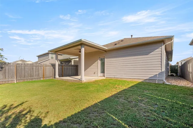 a view of a house with backyard and porch