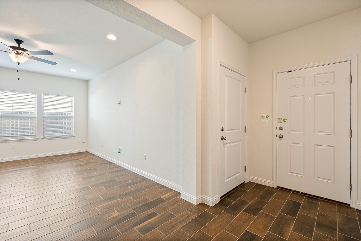 10708 Blacket Drive Austin, TX 78747 - Photo 3 of 20 an empty room with wooden floor and windows