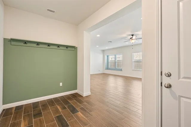 a view of a room with wooden floor and windows