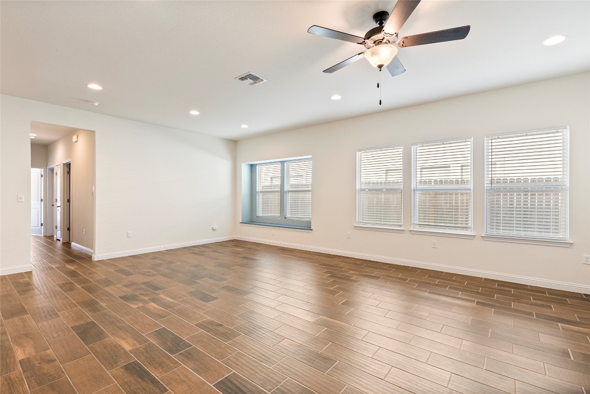 10708 Blacket Drive Austin, TX 78747 - Photo 5 of 20 a view of an empty room with a window and wooden floor