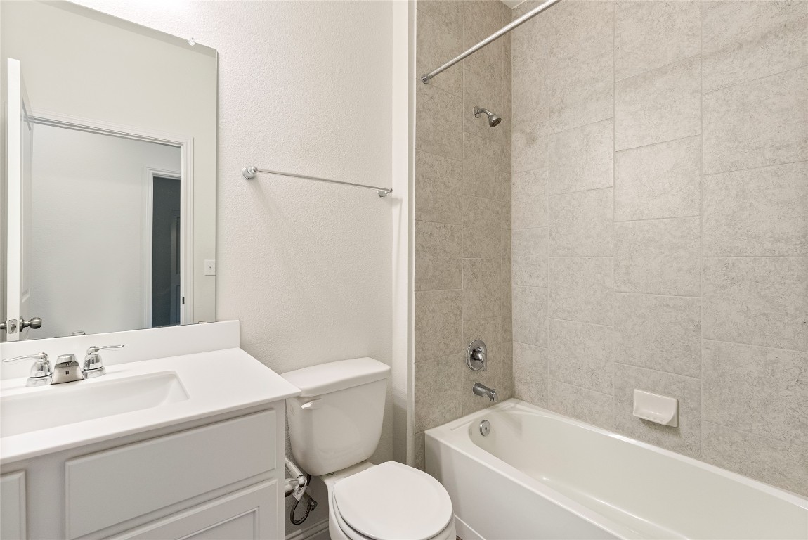 10708 Blacket Drive Austin, TX 78747 - Photo 8 of 20 a bathroom with a sink toilet and shower
