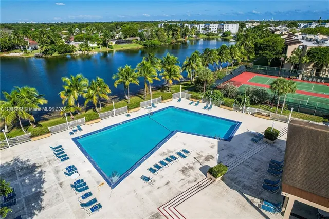 an aerial view of a tennis ground and large trees