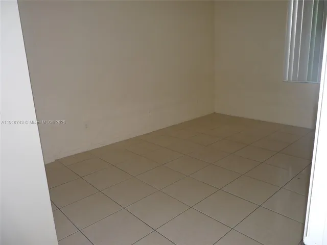 a bathroom with a granite floor a toilet and a bathtub