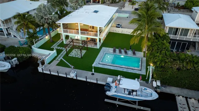 an aerial view of a house with table and chairs