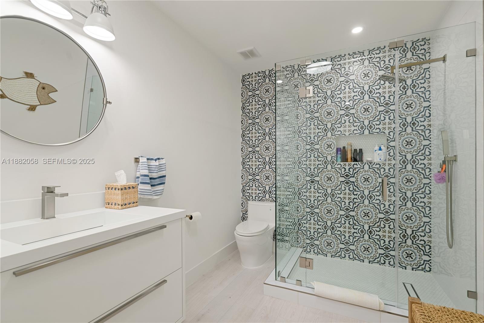 889 Ellen Drive Key Largo, FL 33037 - Photo 15 of 57 a bathroom with a shower a sink and a mirror